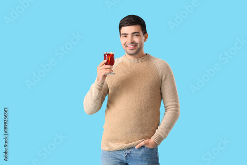 Young man with glass of mul...