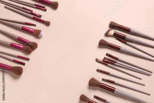 Makeup brushes on pink back...