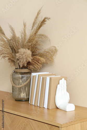 Books and vase with pampas ...