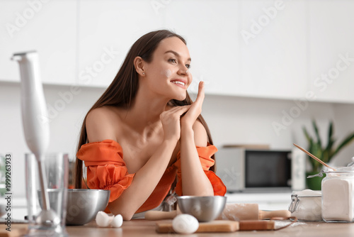 Young woman with flour on h...