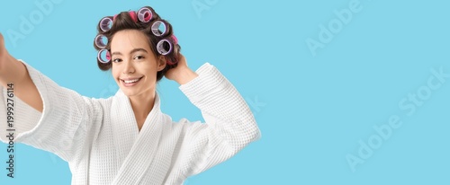 Young woman in bathrobe and...