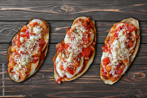 Eggpalnt boat stuffed with mozzarella, tomato and grated Parmisan cheese, neapolitan specialty.