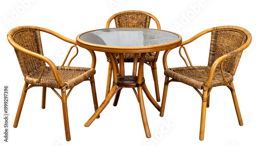 A round table with glass top and three matching rattan chairs, isolated on a black background