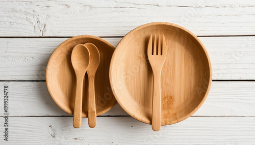 Rustic Wooden Cutlery and Plates Made from Natural Eco Materials Arranged on a White Wood Table
