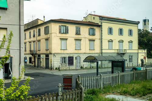 A Quiet Italian Street Corner Featuring a Detailed Study of Weathered Yellow Architecture with Contrasting Textures and Hidden Bell Tower