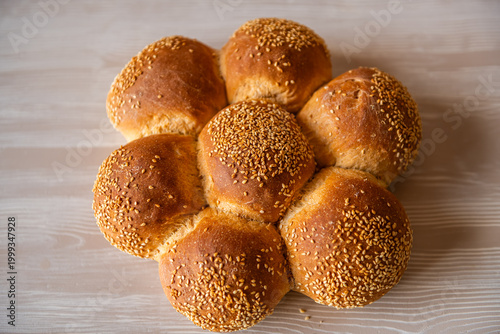 Challah bread rolls with sesame seeds, traditional Jewish food baked at Greek bakery on Ikaria island, Greece macro closeup