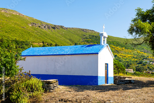 Greek orthodox church small chapel in Perdiki mountain village on Ikaria island, Greece longevity blue zone by garden