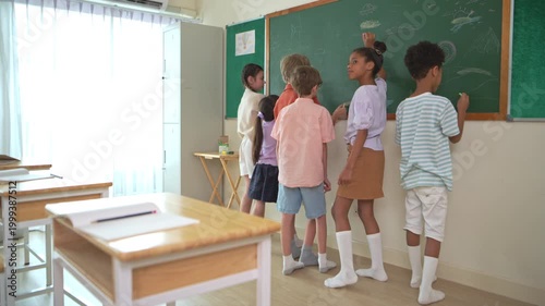 Diverse students writing together on chalkboard in classroom, representing collaborative learning and teamwork