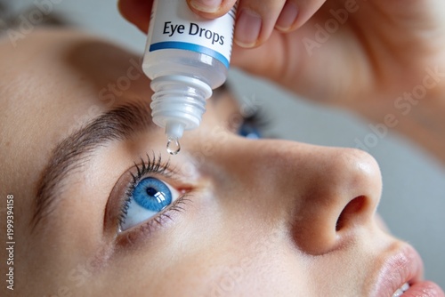 A woman with blue eyes is putting eye drops in her eyes. Close-up.
