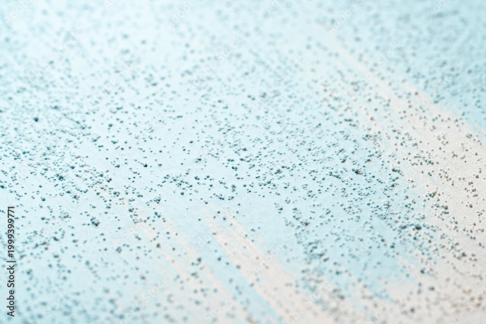 Obraz premium Blue pigment spread on gritty white surface macro view