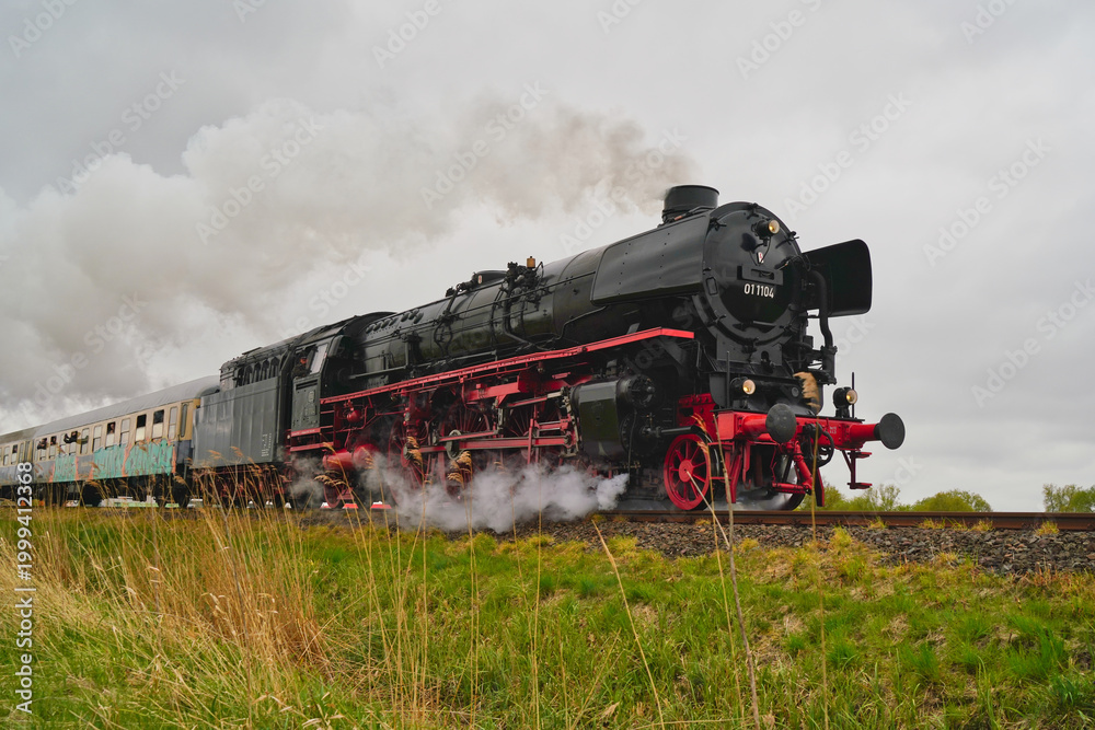 Fototapeta premium Type 01.10 steam engine with passenger train between Bremen and Cuxhaven