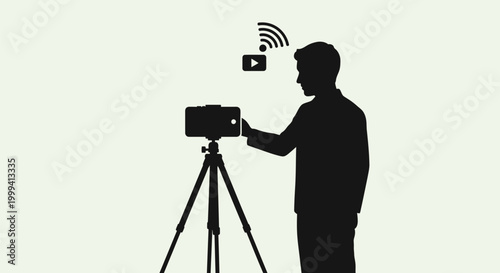 Man Operating Camera on Tripod Stand.