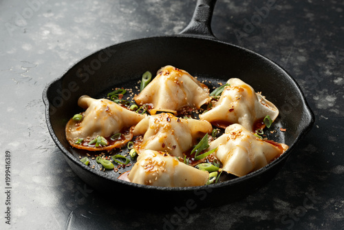 Blanket Dumplings with meat and vegetables in a cast iron pan