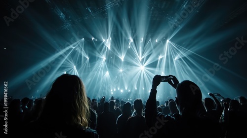 Crowd enjoying live music concert with bright stage lights