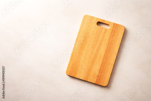Light-colored wooden cutting board on plain background light wood kitchen utensil