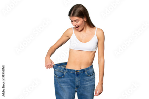 Woman astonished with results of her slimming and weight loss pulling large oversize jeans