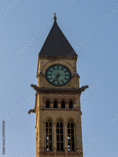 Toronto, Ontario, Canada, June 12, 2025: Front of Old City Hall. The clock tower at Old City Hall is garnished by four stone gargoyles at the upper corners of the tower.