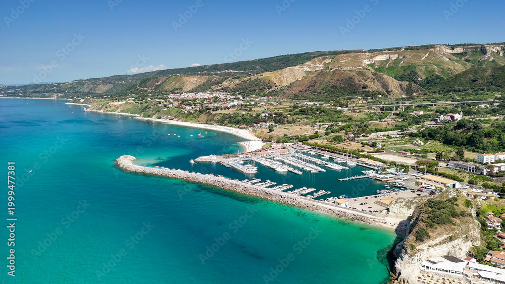 Obraz premium Drone perspective of Tropea in summer showing turquoise sea and scenic coastal landscape