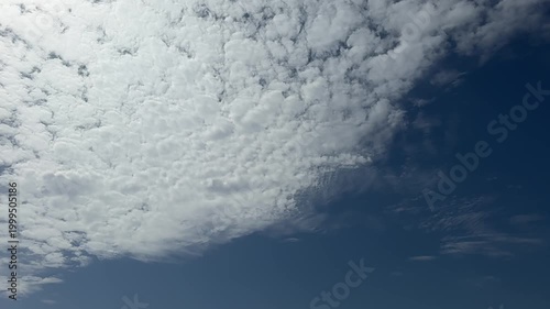 cumulus clouds against a dramatic dark blue background