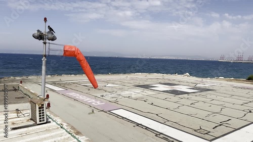 a windsock cone on a helipad near Rambam Health Care Campus in windy weather in Haifa, Israel