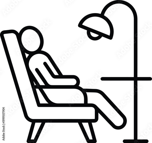 Person sitting in a reclined chair under a floor lamp for relaxation or reading at home