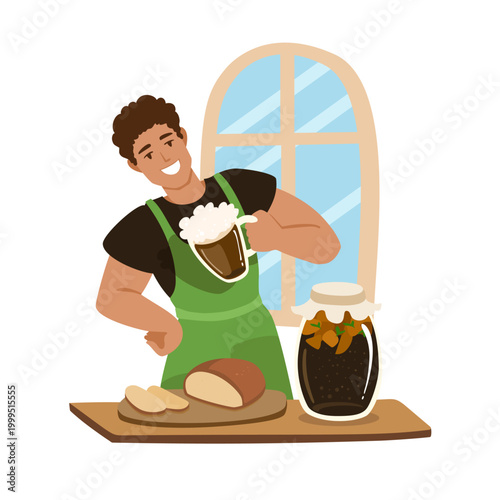 Man brewing kvass through fermentation at home, young adult in an apron holding a mug with froth near bread and mint jar. Homemade beverage making.