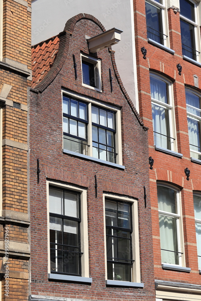 Fototapeta premium Amsterdam Kerkstraat Traditional Brick House Facade with Bell Gable Close Up, Netherlands