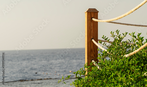 Coastal scene with wooden post and thick rope