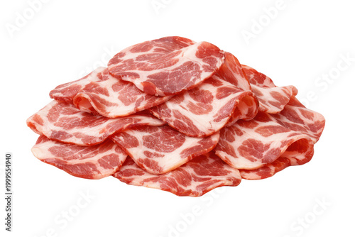 Thinly sliced raw pork shoulder, a pile of fresh capicola meat, uncooked marbled pork for charcuterie boards, gourmet Italian cuisine ingredient.