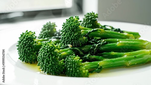 Bright Green Broccoli Rabe On A White Plate