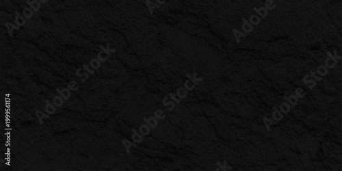Dark black slate stone texture background, Matte charcoal rock surface for minimalist professional graphic design layout. A dark grunge texture with a rough black paper surface, weathered backdrop