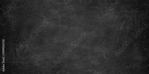 A dark grunge chalkboard backdrop with an empty aged paper texture, vintage grey concrete pattern. Dark charcoal grey slate texture background, moody industrial stone surface. weathered grit and grain