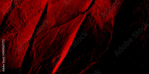 Abstract dark red rock and grunge texture background featuring deep shadows cracked rugged surface and peeling distressed wall details perfect for dramatic horror themes and vintage artwork