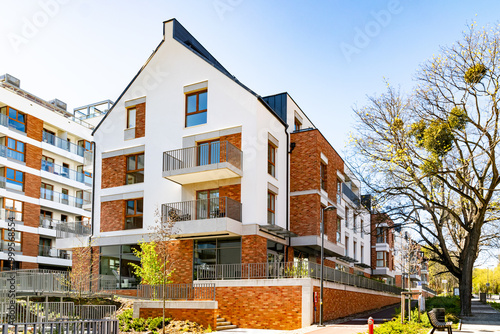 Beautiful new block house in the blooming garden. Housing development in Europe