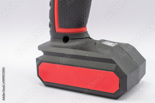 Fotografija Close-up of a modern cordless power drill's black and red rechargeable battery p