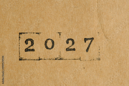 Year 2027 stamped on aged, yellowed paper. Warm, vintage style with visible ink textures.