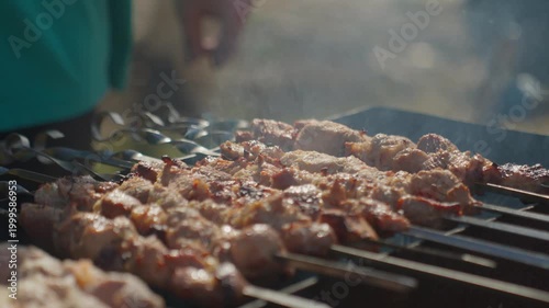 Expert Flips Produce Crispy Edges. Skilled Chef Flips Skewers To Attain Crispy Golden Sides Precisely. Expert Hands Carefully Turn Skewers Over Hot Grill To Create Beautifully Crisp Edges