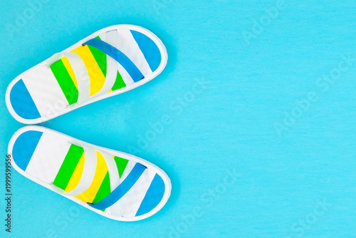 Summer vacation background with beach sandals and vast space for text.