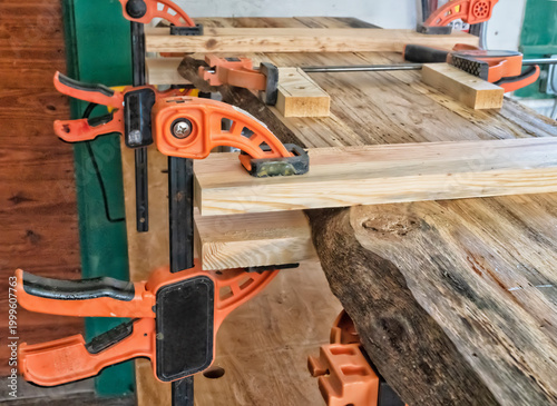 Картината върху платно rustic wood table being made in a workshop with clamps on it