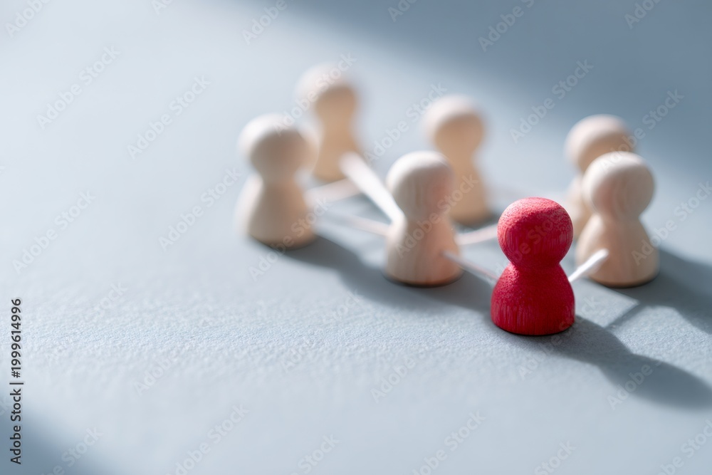 Obraz premium Red leader figure standing out from the crowd in a network. Teamwork, connection, and individuality business concept