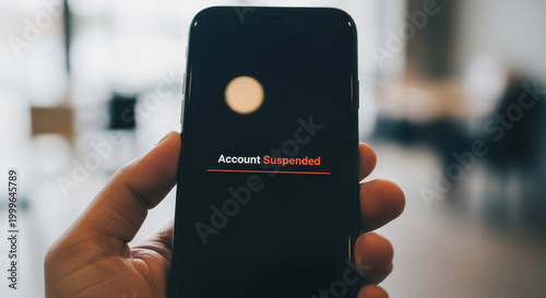 A hand holds a smartphone displaying a stark Account