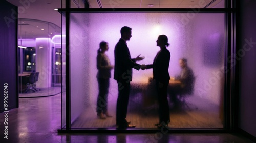 Business handshake with team silhouettes behind frosted glass in purple office
