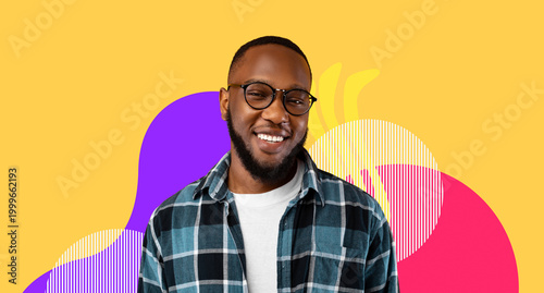 Billede på lærred A young black man stands in front of a yellow studio background