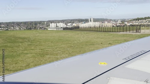 Airplane taxiing past city view from window