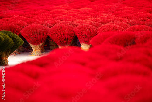 Tableau sur toile Traditional incense stick production in vietnamese village with vibrant red stic