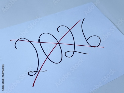 Fotografija Handwritten 2026 crossed out with red line on white paper