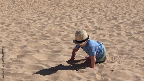 Boy with Down Syndrome Lying in Sand on Beach