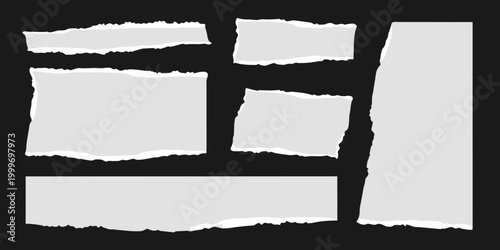 Torn Paper Pieces Isolated: A collection of various torn paper pieces, each with unique ragged edges, artfully arranged against a dark backdrop.