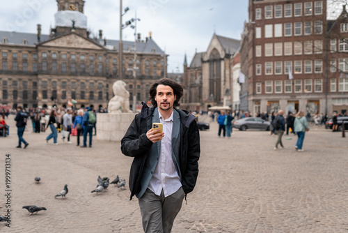 Photography Man using his smartphone to explore the attractions and sites of a bustling euro