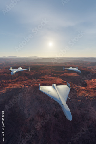 Fotografie Unmanned Stealth Drones Flying in Formation Over Desert Canyon at Sunrise 3D Ren